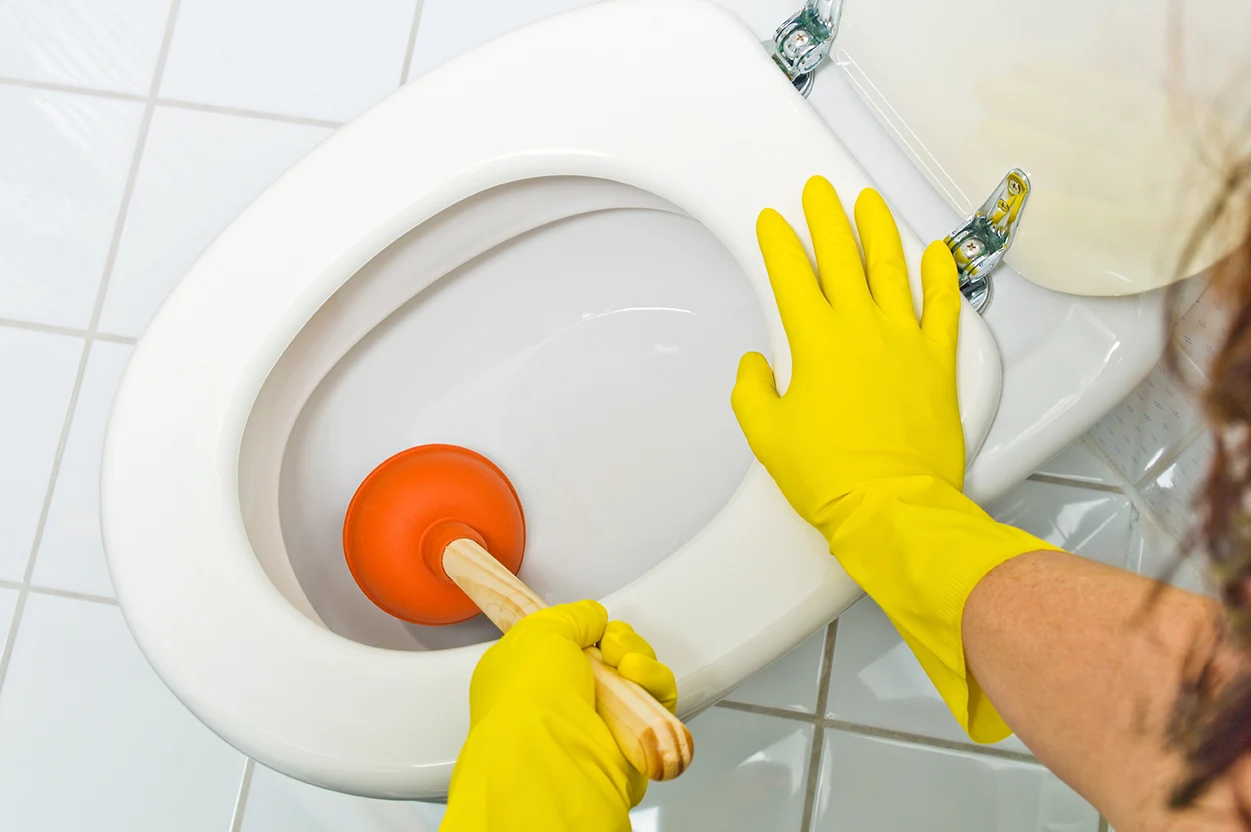 Toilette verstopft Pömpel benutzen und Handschuhe anziehen